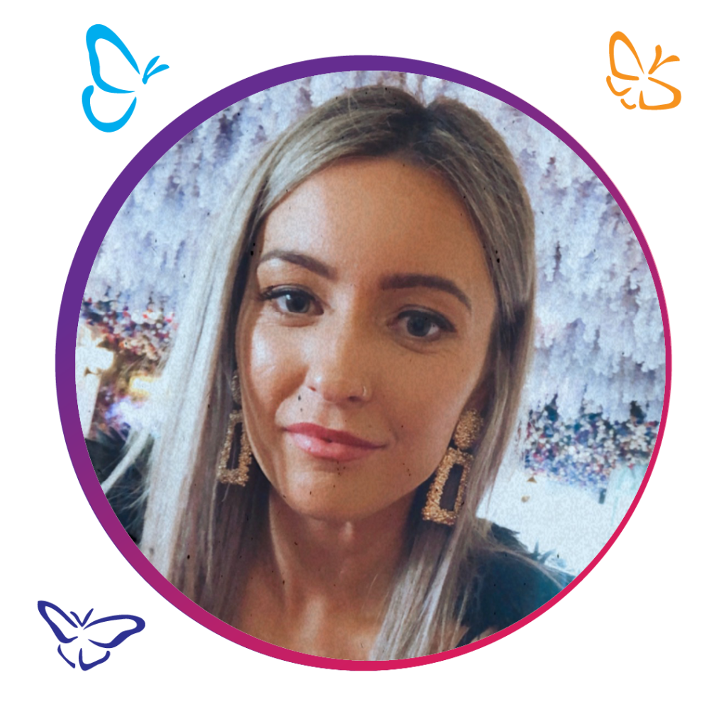 A person with long, straight hair wearing a dark top is framed by a circular border with a gradient of purple and pink. The background showcases a soft, abstract floral pattern in shades of purple and white. Three illustrated butterflies surround the border: a blue butterfly in the top left, an orange butterfly in the top right, and a purple butterfly in the bottom left, adding a whimsical touch to the composition.