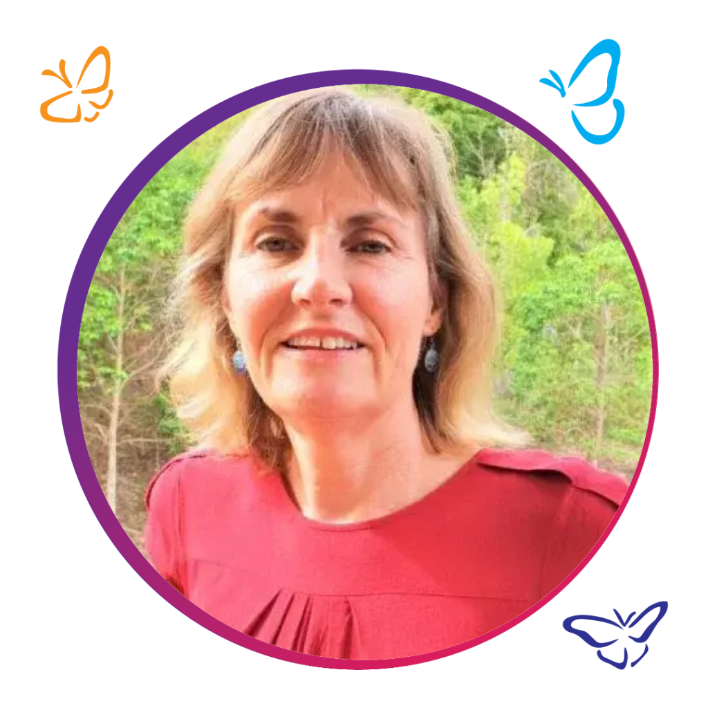 A person wearing a vibrant red top stands outdoors, framed by a soft purple circle. Surrounding the frame, three butterflies—an orange one on the top left, a blue one on the top right, and a purple one on the bottom right—add a whimsical touch. The lush green trees in the background provide a natural contrast to the bright colours.