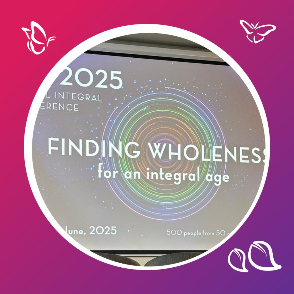 An image of a powerpoint slide from the 2025 "Global Integral Conference" the title says "Finding Wholeness for an integral age". The image is inside a circle with a white boarder. The circle is sitting on a pink and purple background with icons of butterflies and leaves in the corners.