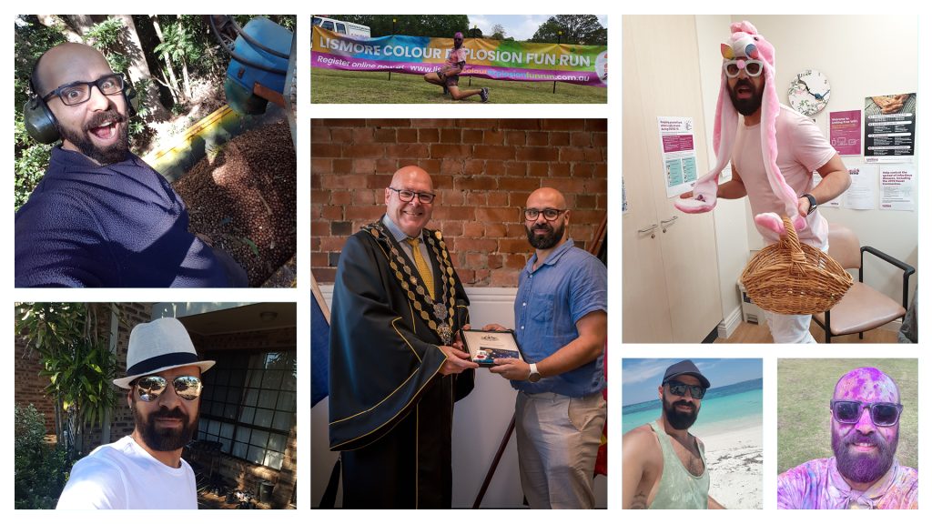 A seven-photo collage featuring the same individual in a variety of joyful, playful, and meaningful moments. Top left: smiling in a selfie near a large tree and a colorful caterpillar sculpture, wearing glasses and a blue shirt. Top center: mid-run at the Lismore Colour Explosion Fun Run, covered in bright powder. Top right: dressed in a pink unicorn costume, holding a wicker basket in a light-filled office or clinic. Middle left: outdoors in front of a brick building and greenery, wearing a white hat and sunglasses. Middle center: receiving an award from a man in ceremonial attire, shaking hands and holding a plaque. Bottom left: at the beach in sunglasses and a white shirt, with ocean waves and sand behind. Bottom right: smiling and covered in purple powder, likely from the same fun run.
