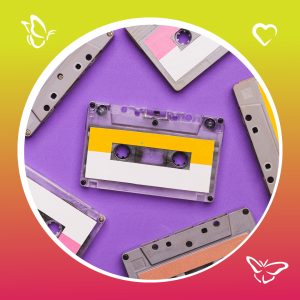 A collection of colorful vintage cassette tapes arranged on a purple background, framed by a circular gradient border from lime green to reddish-orange, with small butterfly and heart icons decorating the corners.