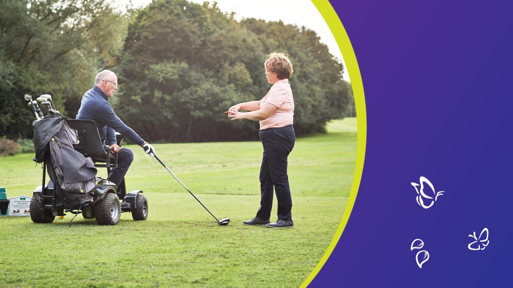 A person seated in a specialised mobility golf cart holds a club and prepares to take a shot on a sunny golf course. Another person stands nearby, gesturing as if offering guidance. The scene is framed on the right by a curved purple-and-yellow border decorated with small white butterfly and leaf icons